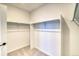 Spacious walk-in closet with carpeted floors and ample storage space for clothing and accessories at 8635 Hotchkiss St, Littleton, CO 80125