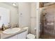 Bathroom featuring a single sink vanity, a toilet, and a glass-enclosed shower with tile surround at 9300 E Florida Ave # 1107, Denver, CO 80247
