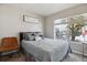 Bright bedroom featuring a comfortable bed, a chair, and a large window overlooking the outdoors at 9300 E Florida Ave # 1107, Denver, CO 80247