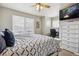 Bright bedroom with large windows, ceiling fan, and dedicated desk/work space at 9300 E Florida Ave # 1107, Denver, CO 80247
