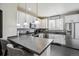 Bright kitchen features white cabinetry, stainless steel appliances, dark countertops and a breakfast bar at 9300 E Florida Ave # 1107, Denver, CO 80247