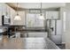 Bright kitchen with white cabinetry, stainless steel appliances, and stylish backsplash at 9300 E Florida Ave # 1107, Denver, CO 80247