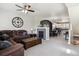 Open concept living room features a fireplace, leather sectional, and views of the kitchen at 9300 E Florida Ave # 1107, Denver, CO 80247