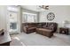 Comfortable living room with a large leather sectional, a wood coffee table, and a ceiling fan at 9300 E Florida Ave # 1107, Denver, CO 80247