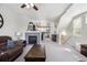 Open concept living room showcasing a fireplace, staircase, and kitchen access, perfect for entertaining at 9300 E Florida Ave # 1107, Denver, CO 80247