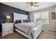 Comfortable bedroom with large bed, blue accent wall, and natural light streaming in at 9300 E Florida Ave # 1107, Denver, CO 80247