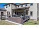 Expansive back patio area featuring a grill, ample seating, and outdoor string lights providing a welcoming ambiance at 230 S Big Meadow Trl, Franktown, CO 80116