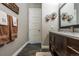 Bathroom features a granite vanity, a modern mirror, and stylish shelving at 230 S Big Meadow Trl, Franktown, CO 80116