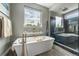 Elegant bathroom featuring a soaking tub, glass shower, and modern fixtures at 230 S Big Meadow Trl, Franktown, CO 80116