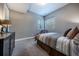 Cozy bedroom features neutral walls, plush carpeting, two windows, a modern bed frame, and a dark wood dresser at 230 S Big Meadow Trl, Franktown, CO 80116