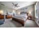 Cozy bedroom features neutral colors, wood accents and natural light at 230 S Big Meadow Trl, Franktown, CO 80116