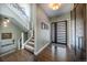 Inviting entryway with a modern front door, a staircase with iron railings, and gleaming hardwood floors at 230 S Big Meadow Trl, Franktown, CO 80116