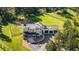 Striking home featuring a grand entryway, an attached three-car garage, and a manicured front lawn at 230 S Big Meadow Trl, Franktown, CO 80116