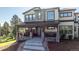 Attractive home showcasing a covered porch with stone columns and a metal roof, complemented by well-maintained landscaping at 230 S Big Meadow Trl, Franktown, CO 80116