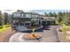 Stunning two-story home featuring stone accents, a covered front porch, and an expansive driveway with a circular turnaround at 230 S Big Meadow Trl, Franktown, CO 80116