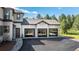 Detached three-car garage with modern glass doors and neutral stucco, providing ample parking and storage space at 230 S Big Meadow Trl, Franktown, CO 80116