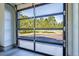 Modern glass garage door providing a scenic view of the wooded property at 230 S Big Meadow Trl, Franktown, CO 80116