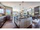 A spacious kitchen boasts an island with seating, stainless appliances, and flows into the dining area at 230 S Big Meadow Trl, Franktown, CO 80116