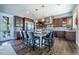 Gourmet kitchen boasts stainless steel appliances, a large island with seating, and custom cabinetry at 230 S Big Meadow Trl, Franktown, CO 80116