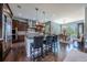 Well-appointed kitchen with stainless steel appliances, a large island, and an adjacent dining area filled with natural light at 230 S Big Meadow Trl, Franktown, CO 80116