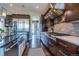 The gourmet kitchen features professional-grade appliances, custom cabinetry, and a spacious layout at 230 S Big Meadow Trl, Franktown, CO 80116