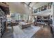 Open-concept living space with soaring ceilings, a cozy fireplace, and an upstairs library at 230 S Big Meadow Trl, Franktown, CO 80116