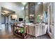 Spacious living room with a floor-to-ceiling stone fireplace, large windows, and stylish decor at 230 S Big Meadow Trl, Franktown, CO 80116