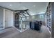 The cozy loft features exposed beams, a stone accent wall, and built-in bookshelves at 230 S Big Meadow Trl, Franktown, CO 80116