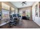 Bright and airy office with plenty of natural light, built-in shelving, and ample workspace at 230 S Big Meadow Trl, Franktown, CO 80116