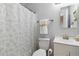 Cozy bathroom with neutral gray walls, a shower with a decorative curtain, toilet, and white vanity at 5425 W 115Th Pl, Westminster, CO 80020