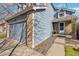 Exterior of a blue home with a two-car garage and brick accents at 5425 W 115Th Pl, Westminster, CO 80020