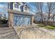 Exterior of a two-story blue house with a two-car garage and driveway at 5425 W 115Th Pl, Westminster, CO 80020