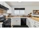 Kitchen featuring white cabinets, black appliances, and lots of natural light at 5425 W 115Th Pl, Westminster, CO 80020
