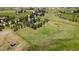 Wide aerial view of the property showing a lush, green landscape with scattered trees at 723 Brussels Dr, Parker, CO 80138