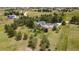 An aerial view features a home and large lot with surrounding trees at 723 Brussels Dr, Parker, CO 80138