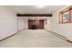 Finished basement with brick fireplace and neutral carpet at 723 Brussels Dr, Parker, CO 80138