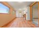 Versatile bonus room with charming terra cotta tile flooring and natural light at 723 Brussels Dr, Parker, CO 80138