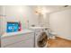 Bright laundry room featuring modern appliances and ample storage for cleaning supplies at 723 Brussels Dr, Parker, CO 80138