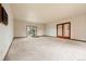 Bright living area featuring neutral carpet, ample space, and sliding glass doors for natural light at 723 Brussels Dr, Parker, CO 80138