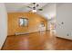Spacious living room with hardwood floors and wood-paneled wall, offering a warm and inviting atmosphere at 723 Brussels Dr, Parker, CO 80138
