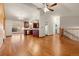 Open-concept living area with hardwood floors, connecting kitchen, and staircase at 723 Brussels Dr, Parker, CO 80138