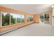 Bright living room featuring large windows with scenic views and access to outdoor deck at 723 Brussels Dr, Parker, CO 80138