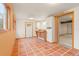 Bright mud room featuring terra cotta tile, built-in cabinets, and access to other rooms at 723 Brussels Dr, Parker, CO 80138