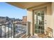 Balcony view of city buildings with metal railing and a wooden chair at 300 W 11Th Ave # 4F, Denver, CO 80204