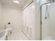 Bathroom featuring tile floors, sleek white cabinets and a glass-enclosed shower at 300 W 11Th Ave # 4F, Denver, CO 80204