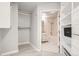 Bathroom with tiled shower, bathtub, vanity, and access to a walk-in closet at 300 W 11Th Ave # 4F, Denver, CO 80204