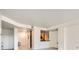 Spacious living room with light-colored walls, a pass-through kitchen, and elegant lighting at 300 W 11Th Ave # 4F, Denver, CO 80204