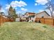 Large fenced backyard with a playset and storage shed, perfect for outdoor activities and relaxation at 3973 S Joplin Way, Aurora, CO 80013
