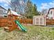 Backyard features a playset with slide and swing, as well as a storage shed, and wood fence at 3973 S Joplin Way, Aurora, CO 80013
