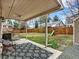 Outdoor patio with chair, grill, and backyard featuring a playset and fenced yard at 3973 S Joplin Way, Aurora, CO 80013